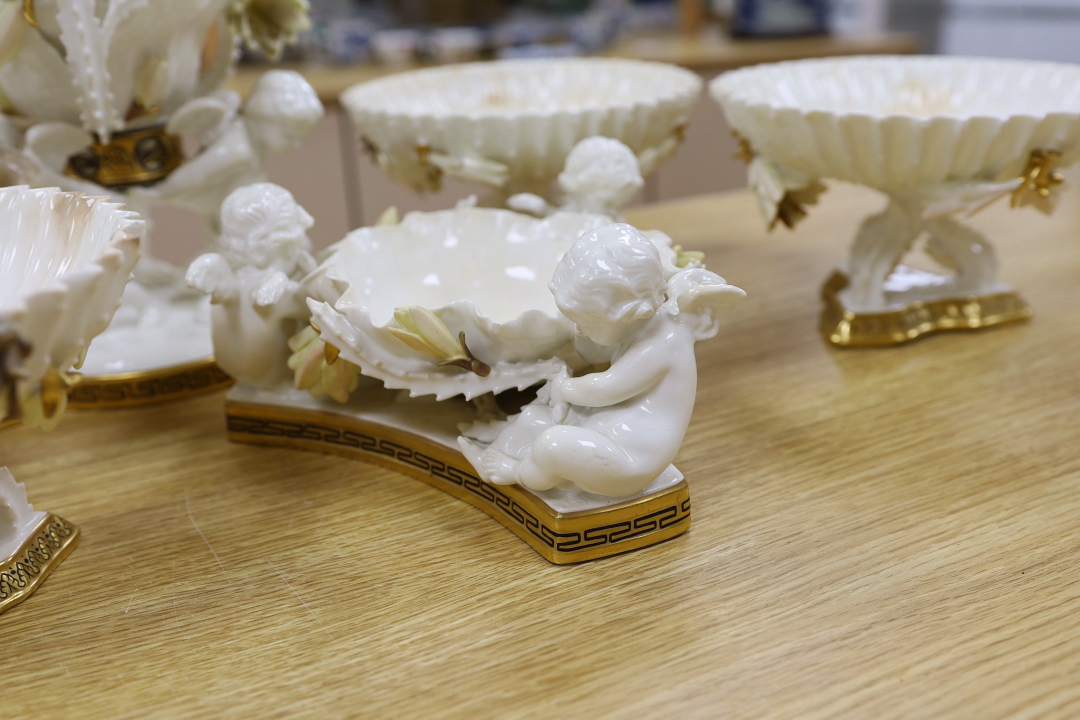 Six pieces of Moore Bros. white glazed gilt edged porcelain, including a set of four comport, 20cm tall